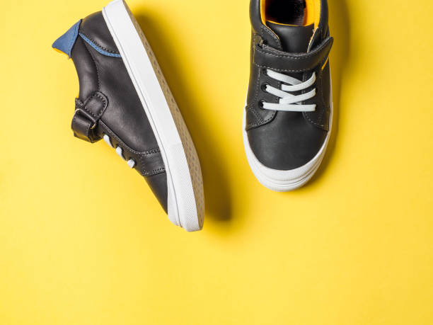 istock Gray and yellow sneakers on yellow background 1222020140