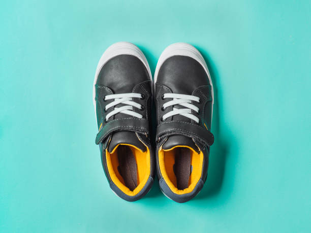 istock Gray and yellow sneakers on blue background 1222020225