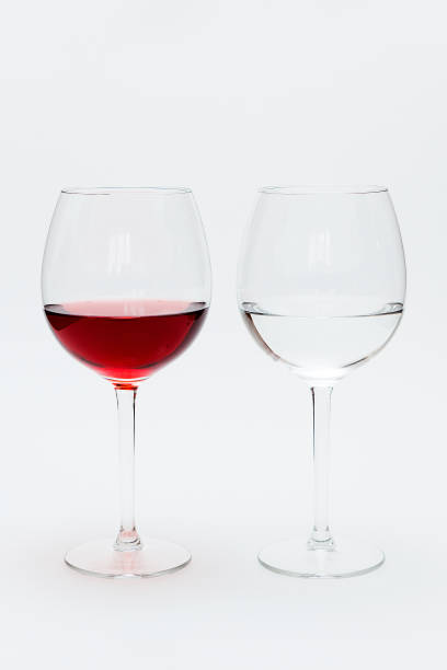 istock Glasses with red and white wine and water on a white table 1222020641