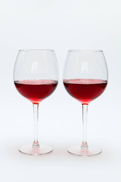istock Two glasses of red wine stand on a white table. 1222020789