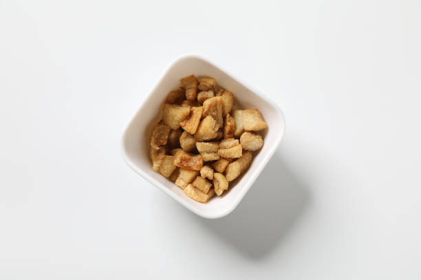 Delicious fat food, fried greaves pork in a bowl on white background.