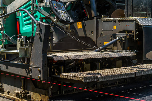 Heavy roller at work paving asphalt, road repairing.
