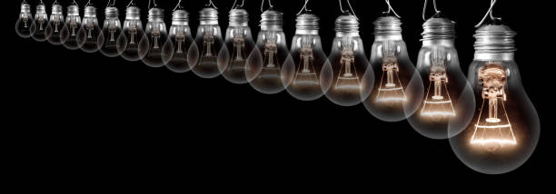 istock Dark and Shining Light Bulbs Growing Row 1222023109