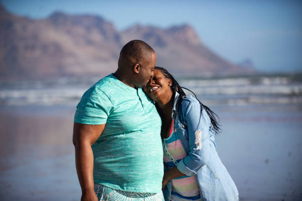 istock Happy beach walking couple 1222023491