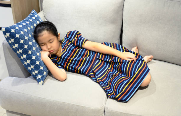 istock Little asian girl sleeps on a couch 1222025517