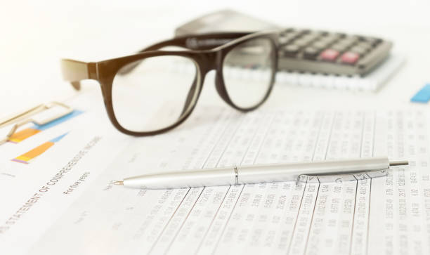 istock eyeglasses and calculator on the paper tables 1222026531