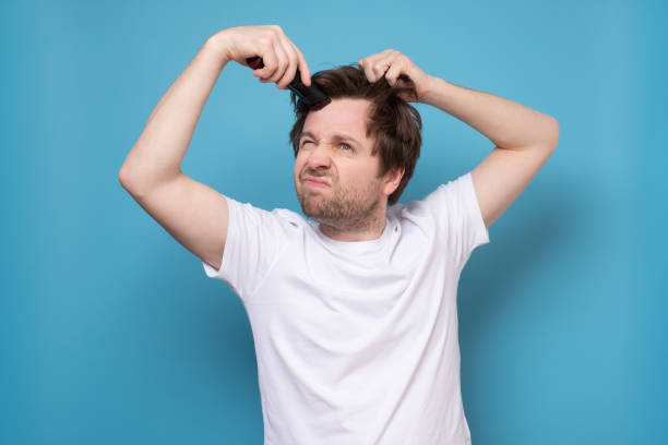 istock man trying to make a hairstyle by himself with scissors being on quarantine 1222027266