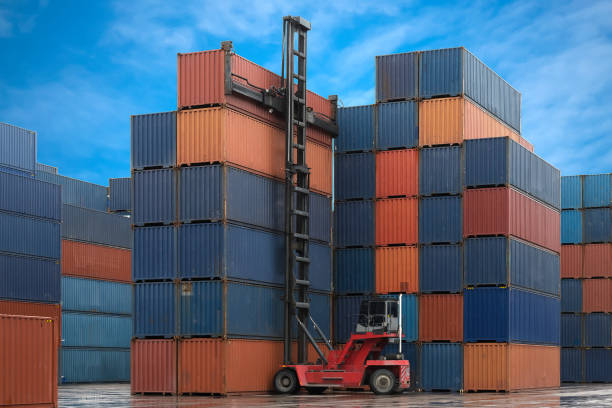 istock crane lifting up a container cargo in shipyard for import export with logistics area background 1222027375