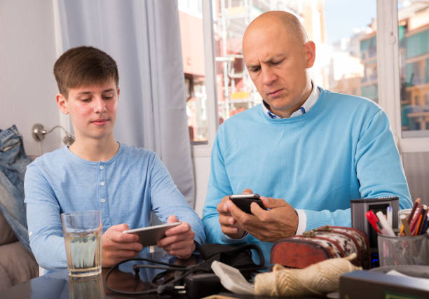 istock Father and son using smartphones 1222027467