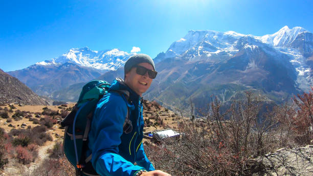 istock Praken Gompa - A man hiking with Annapurna chain in the back 1222029120