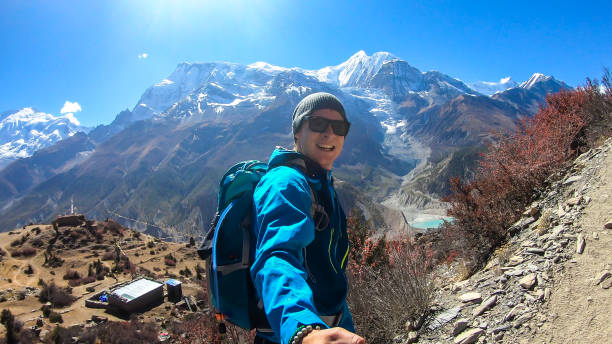 Praken Gompa - A man hiking with Annapurna chain in the back