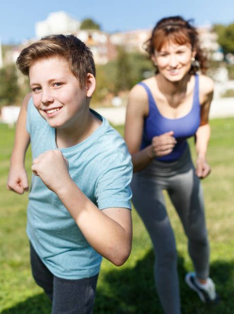 istock Mother and son running together 1222029736