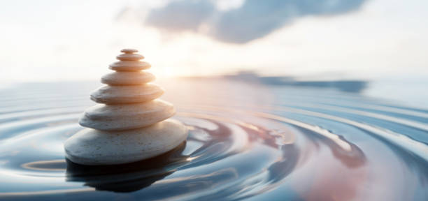 istock Zen stones arranged in pyramid balanced on water. Spa calm harmony 1222030620