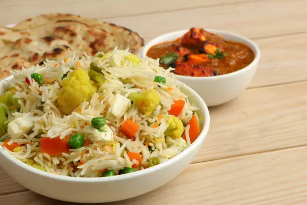 Photo of Veg Pulao with paneer tikka masala, and lachha paratha