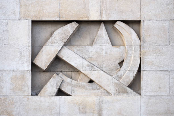 Stone bas-relief in the form of a symbol of the USSR. Sickle, hammer and star Stone bas-relief in the form of a symbol of the USSR. Sickle, hammer and star marxism stock pictures, royalty-free photos & images