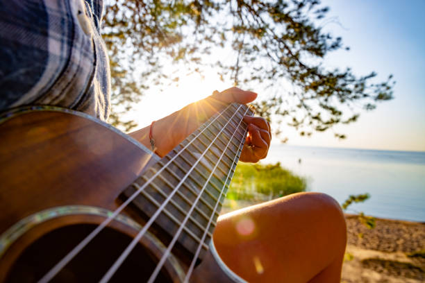 istock Woman at sunset holding a ukulele 1222034052