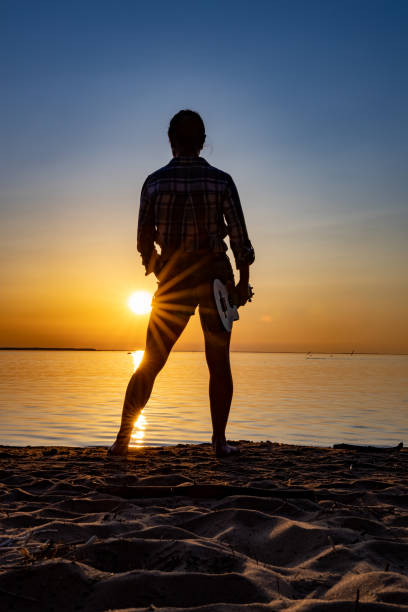 istock Woman at sunset holding a ukulele 1222034078