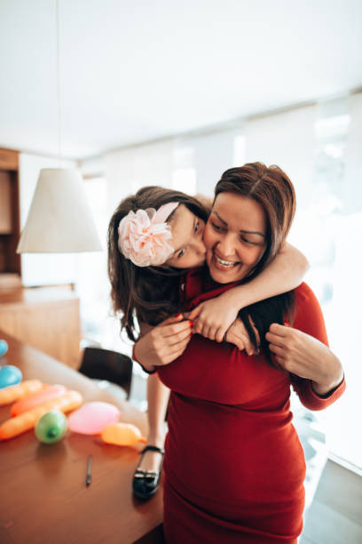 istock mother and daughter doing an home party 1222034344
