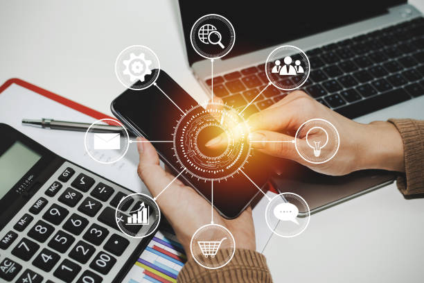 istock woman hand working about financial on digital mobile phone with virtual icon, laptop computer and report on desk at home office, digital marketing, work from home, business finance, technology concept 1222034396