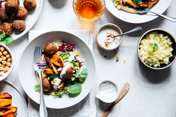 Vegan falafel bowl on tablet with ingredients around Directly above view of fresh vegan meal. Vegan falafel bowl with ingredients around on table. sweet potato photos stock pictures, royalty-free photos & images