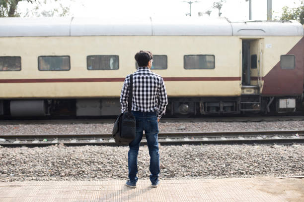 Man waiting at railroad station platform
