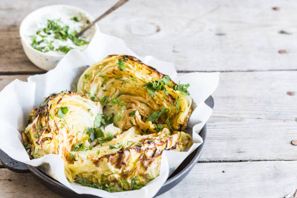 Baked cabbage slices. Vegan diet. Healthy grilled cabbage steaks with souse, spices and herbs. stock photo