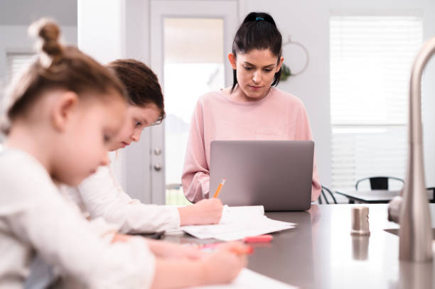 istock Mid adult mom concentrates while telecommuting from home 1222039122