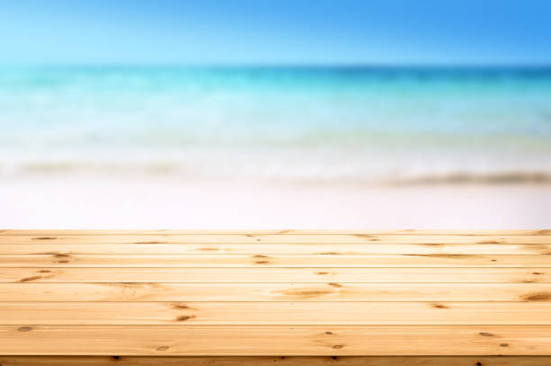 istock Wood board desk and un focus Sandy Beach Summer background 1222040794