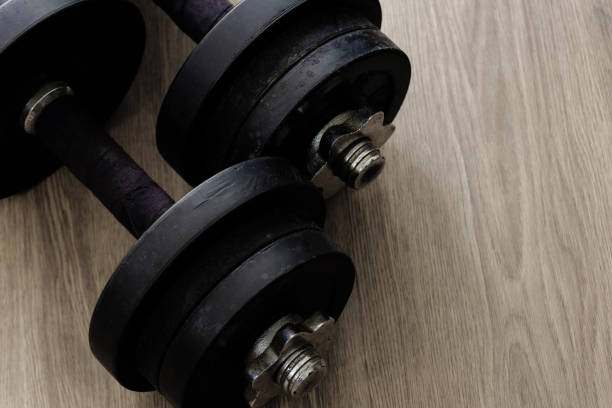istock black color old rusty dumbbells on wood floor surface 1222044375