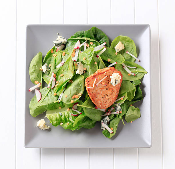 Spinach salad and marinated pork chop  side salad stock pictures, royalty-free photos & images