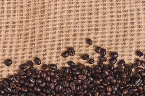 istock Close up roasted coffee beans on sackcloth background with copy space 1222045107