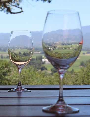 Vertical image of two wine glasses prior to tasting at Vinyard