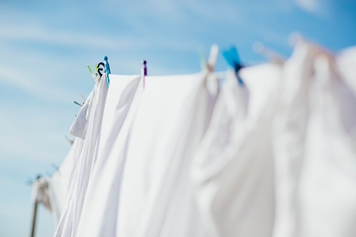 Wet clothes drying in the sun. Laundry  hanging in back yard. Galicia, Spain.