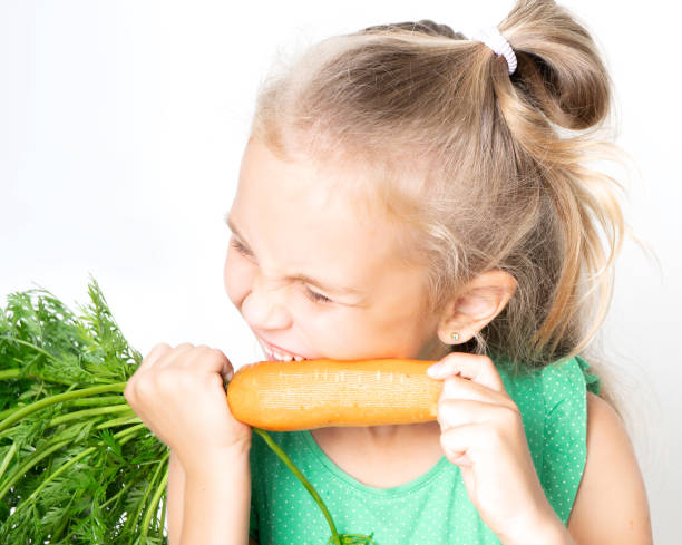 istock A child with a vegetable carrots 1222047457