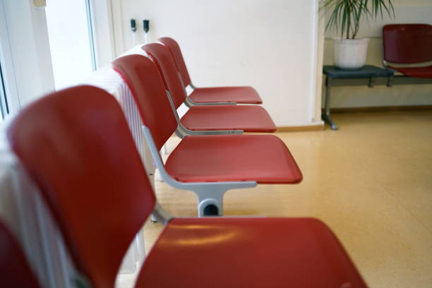 istock Waiting room with red chairs and beige linoleum floor 1222047468