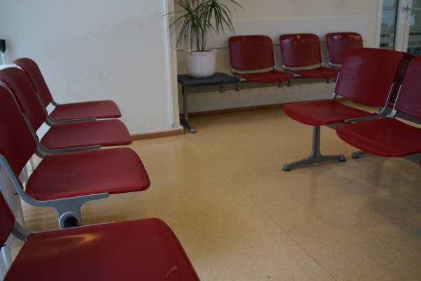 Waiting room with red chairs and beige linoleum floor
