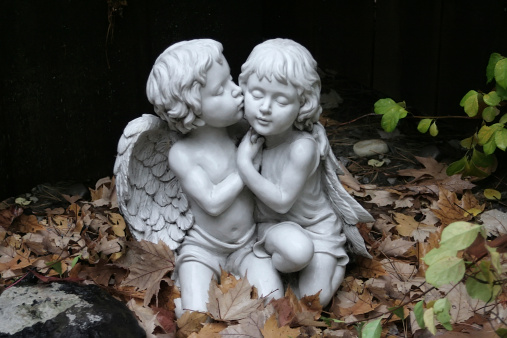Two cherubs kneel in the woods for a kiss. Please check out other images in my 