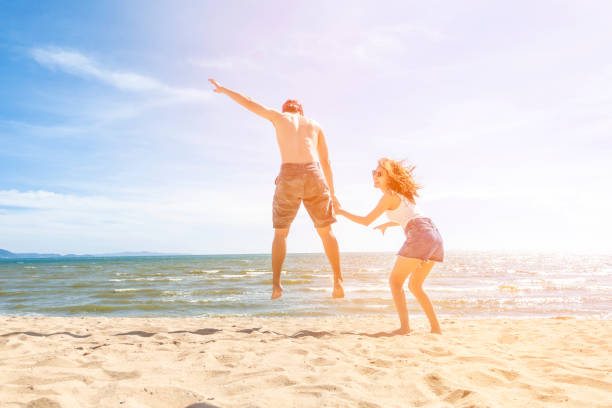 istock Couple is Jumping  in beach 1222049777
