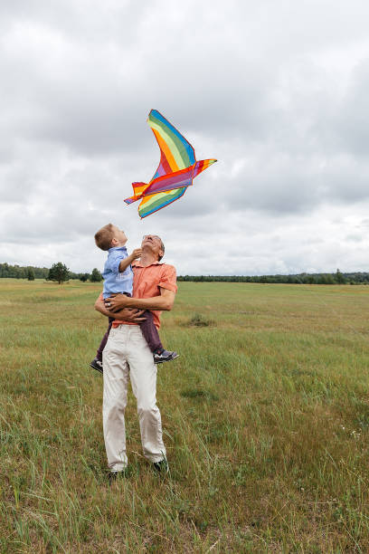istock A family flies a kite on the field. 1222049916