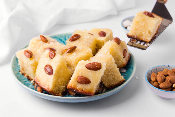 istock arabic sweet Basbus pie sliced in pieces on a white background 1222050661