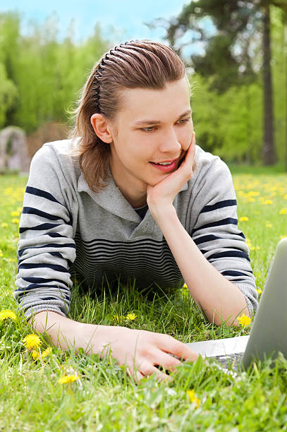 istock smiling man with laptop outdoor 122205085