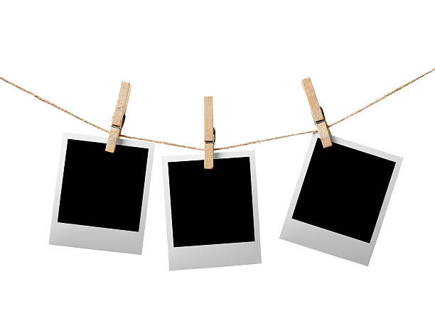 istock Three blank picture frames hanging on clothesline 122205118