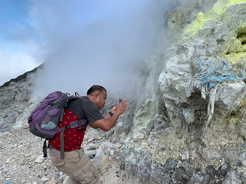 A Man Takes Photo of Sibayak Volcano in Sumatra Island, Indonesia
