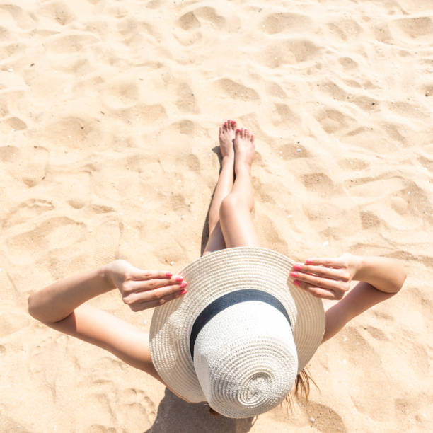 istock Beautiful woman is sitting on beach 1222053802