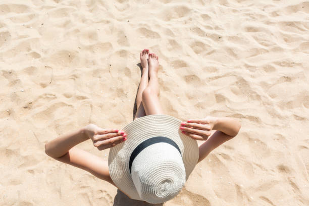 istock Beautiful woman is sitting on beach 1222053875