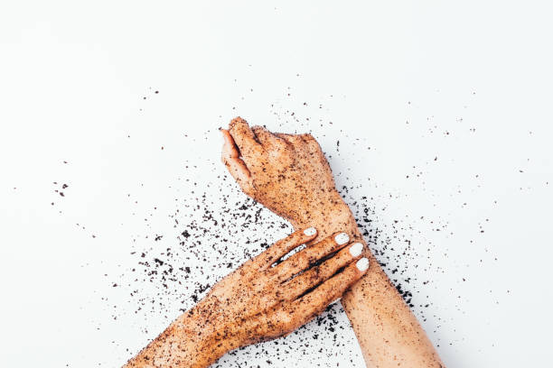 istock Female hands apply exfoliating coffee body scrub 1222053957