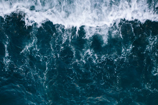 istock Overhead view to blue stormy ocean waves 1222053998