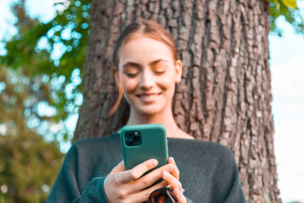 istock Young woman reading messages on mobile phone 1222054073