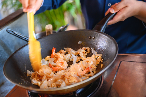 Unrecognizable chef stir frying shrimps in wok, Nikon Z7
