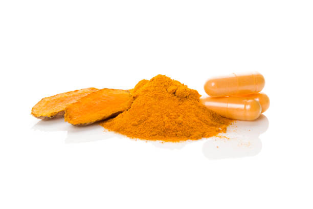 istock Curcumin root, turmeric powder and gel capsules on white background. 1222055692